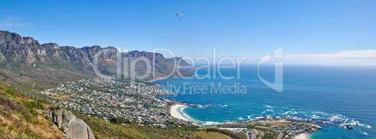 Landscape of the stunning beach during day in summer. Sea and 12 apostles mountain range in a beautiful high up view and famous tourist travel destination in the city of Cape Town with copy space.