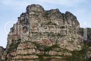 Panorama view of Lions Head mountain in Cape Town, South Africa during summer holiday and vacation. Scenic landscape of rock and texture hill in a remote hiking area against blue sky.