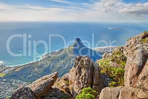Aerial view of a calm ocean and a mountain with blue cloudy sky background and copy space. Beautiful nature landscape of the sea and horizon from Table Mountain tourism attraction in Cape Town