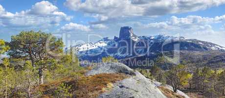 Landscape view of mountain snow, blue sky with clouds and copy space in Norway. Hiking, discovering scenic countryside on cold winter day. Sun shining on vast background of nature expanse with trees