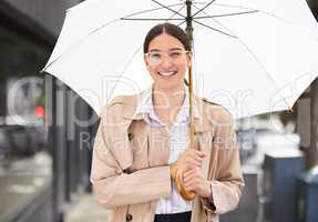 Cover that fits your unique needs. Portrait of a young businesswoman carrying an umbrella while out in the city.