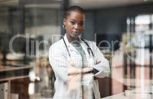 Saving lives is my calling. a female doctor proudly standing in her office.