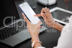 Im always busy, thats why I need convenience. an unrecognizable businesswoman using her cellphone while sitting at her desk.