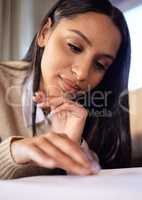 Studying hard makes getting As look easy. a beautiful young woman studying at home.