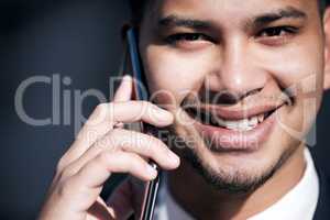 Im sealing the deal on the phone right now. Portrait of a young businessman talking on a cellphone while out in the city.