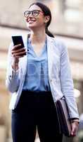 Youll never regret taking the chance. a young businesswoman using her smartphone to send a text message.