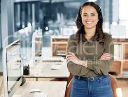 Tell us your thoughts. Portrait of a young businesswoman using a headset in a modern office.