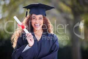 My new beginnings are here. Portrait of a young woman holding her diploma on graduation day.