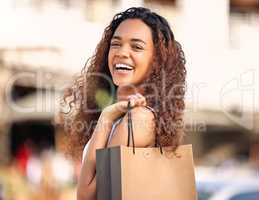 No better way to spend the way. a young woman enjoying a day of solo shopping.
