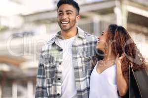 Your smile brightens my day. a young couple spending the day shopping together.