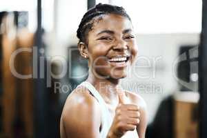Im so ready for my workout. an attractive young woman standing alone in the gym and showing a thumbs up during her workout.