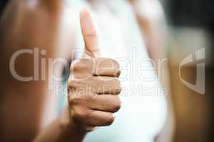 Staying healthy is the way forward. an unrecognisable woman standing alone in the gym and showing a thumbs up during her workout.