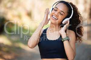 Let the music fill your soul. a young woman listening to some fun music before a run.