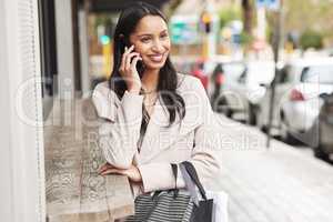 Ive been working hunting for deals. a woman making a call using her cellphone to make a phone call.