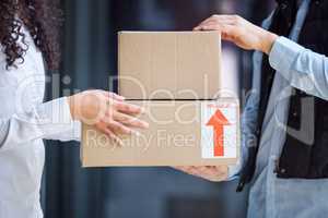 Be careful, its fragile. Closeup shot of an unrecognisable man making a delivery to a customer.