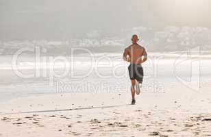 Great works are performed, not by strength, but by perseverance. a man running on the beachv.