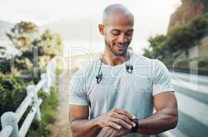 Being weak is dangerous. a man using his watch to track his pulse while out for a workout.