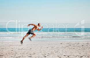 Perseverance is the hard work. a young man sprinting on the beach.