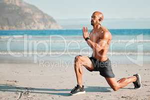 If something stands between you and your success, move it. a young man doing lunges on the beach.