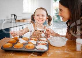 Mom says that Im like the icing to her life. a woman baking with her daughter at home.