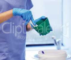 The makings of a dental mould. an unrecognisable dentist preparing plaster to make a mould during a dental procedure.