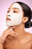 So smooth, so good. Studio shot of an attractive young woman having a facial against a pink background.