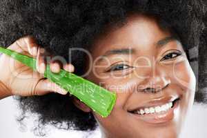 Say aloe to my little skincare friend. Studio shot of an attractive young woman posing with an aloe plant plant against a grey background.