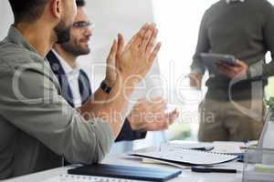 Clap for every little achievement. two businesspeople clapping in a meeting at work.
