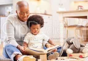 Enter your imagination with a good book. a young mother and daughter playing in the lounge at home.