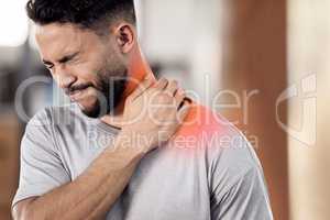 No pain, no gain. a muscular young man holding his neck in pain while exercising in a gym.