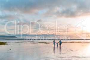 Bonding at sunset. a beautiful family bonding while spending a day at the beach together.