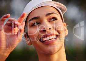 Heres to having more good days. Closeup shot of a tennis player wearing a white visor.