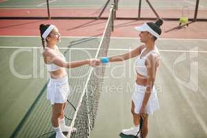 May the best player win. two young tennis players standing together and shaking hands before practice.