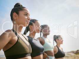 Looking out at a certain future. a group of friends looking strong during a workout session.