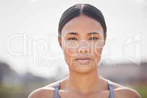 Focused on becoming the best. Cropped portrait of an attractive young female athlete standing outside on the track.
