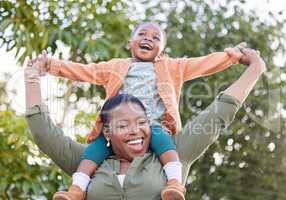 My little girl with a big personality. an adorable little girl enjoying a piggyback ride with her mother in a garden.