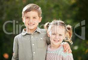 Hes my big brother. an adorable little boy and girl standing outside.