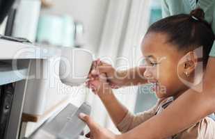 Spend more time with family and less time with chores. a little girl putting a cup into the dishwashing machine at home with her mother.