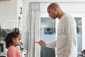 That behaviour is unacceptable. a little girl being spoken to sternly at home by her father.