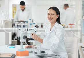 Scientific invention and discoveries have made many things possible. Portrait of a young scientist using a microscope in a lab.