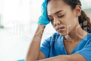 Only a life lived for others is a life worthwhile. a female nurse looking stressed while sitting in a hospital.