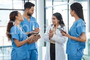 Medicine cure diseases but only doctors can cure patients. a group of medical practitioners having a discussion in a hospital.