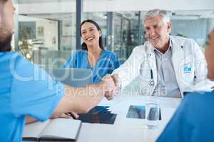 Ready to save lives. a doctor shaking hands with a new hire.