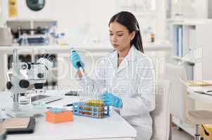 My research will contribute to a whole lot more. a young scientist working with samples in a lab.