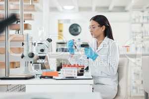 Sorting through samples for further analysis. a young scientist using a barcode reader while working with samples in a lab.