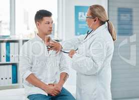 This is a cause for concern. a doctor examining a patient with a stethoscope during a consultation in a clinic.