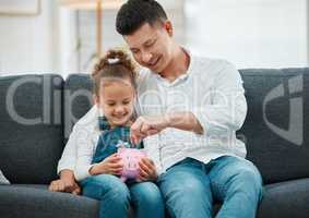 Be smart when investing. a father teaching his daughter to save in a piggybank.