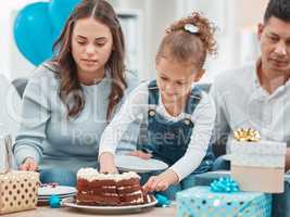 A special treat for a special day. a happy family celebrating a birthday at home.