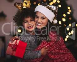 Hes the best gift Ive ever received. a young mother and son exchanging Christmas gifts at home.