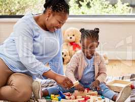 What can we build with these. a little girl playing with blocks with her grandma at home.